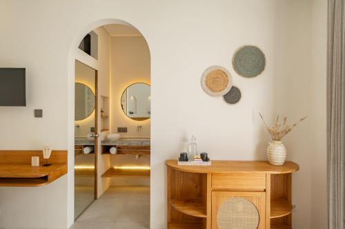a bathroom with a vanity and a mirror at Mysa Boutique Hotel in Seminyak