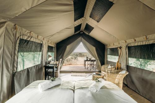 a bedroom in a tent with two beds at Mapesu Wilderness Tented Camp in Musina