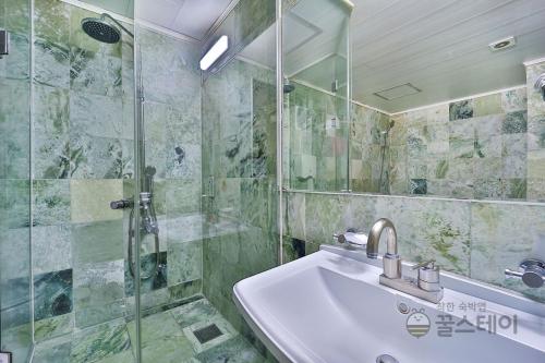 a bathroom with a sink and a shower at HOTEL airport June in Incheon