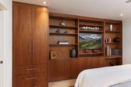 a bedroom with a bed and a wooden cabinet at Luxurious 2 BR, 2 BA - Aspen Core in Aspen