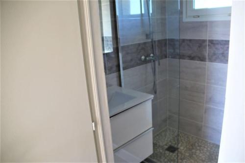 La salle de bains est pourvue d'une douche et d'un lavabo blanc. dans l'établissement Appart 486, Port nature 4 au village naturiste, au Cap d'Agde