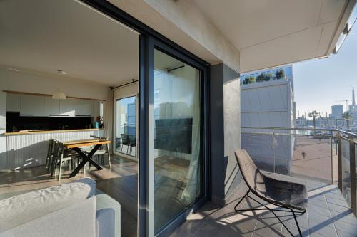 a balcony with a couch and a table on a building at Gran Apartmento Playa Badalona in Badalona