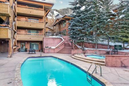a large swimming pool in front of a building at New Listing 3BR 3BA Condo - Steps to Gondola in Aspen