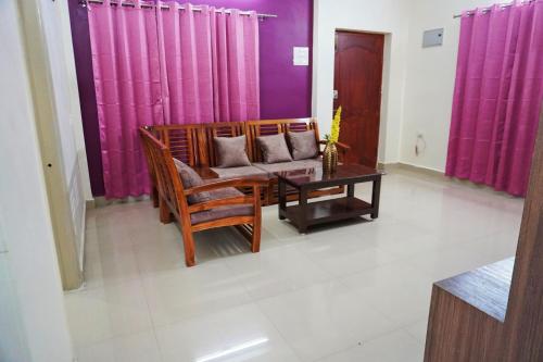 a living room with a couch and a table at ABS Home Stay, 2Bed room AC Flats,Tirupati in Tirupati