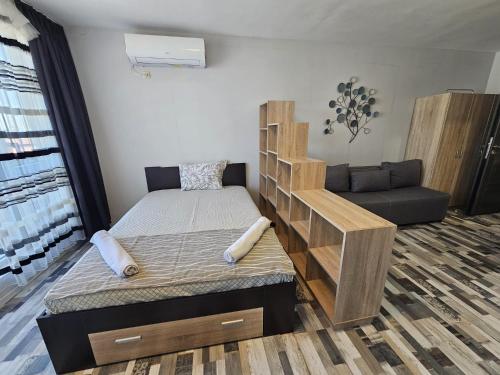 a bedroom with a bunk bed and a couch at Studio Apartament 47А- Trakia 54 А in Plovdiv
