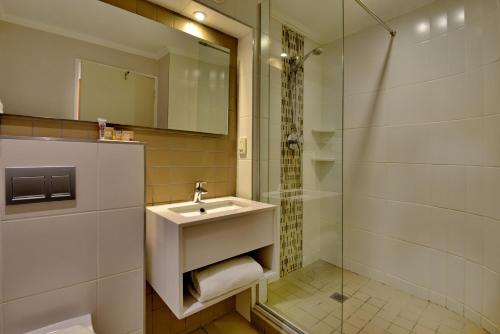a bathroom with a sink and a shower at Town Lodge Waterfall, Midrand in Midrand