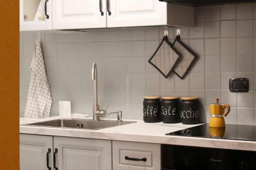 a kitchen counter with a sink and two mugs at Sancisi 3 in Santarcangelo di Romagna