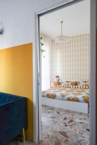 a bedroom with a bed in a room with yellow walls at Sancisi 3 in Santarcangelo di Romagna
