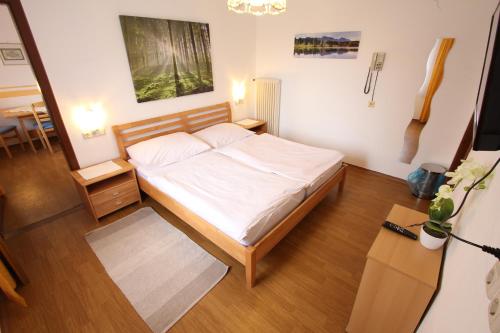 a small bedroom with a bed and a table at CProoms24 in Miesenbach