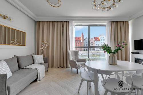 sala de estar con sofá y mesa en Lion Apartments - The Palace premium apartment with Old City & River View en Gdansk