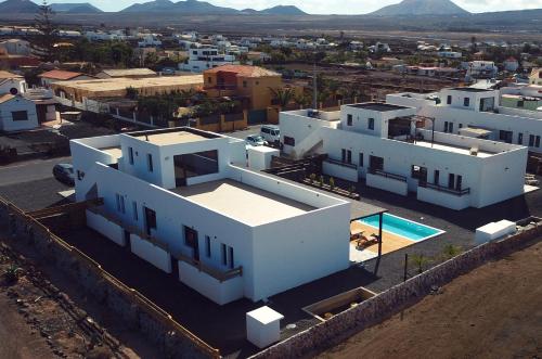 an aerial view of a white house with a pool at NaoClub Fuerteventura in Lajares