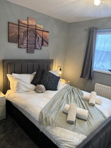 a bedroom with a bed with two towels on it at Cosy Corner - 2 bed house with parking! in Southampton