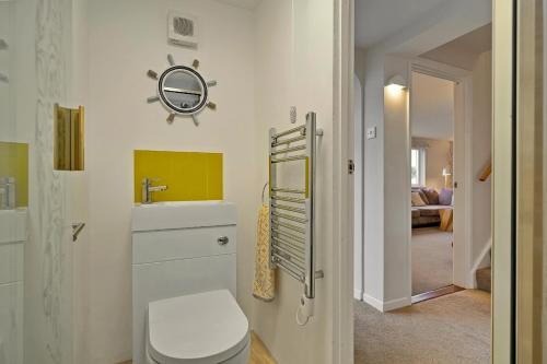 a bathroom with a toilet and a sink and a room at Finest Retreats - Beyond The Blue in Porthleven