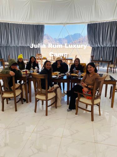 a group of people sitting at a table at Julia Rum Luxury Camp in Wadi Rum