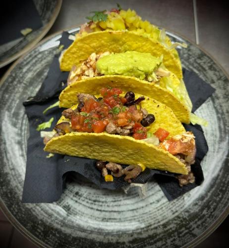 two tacos on a plate with salsa and guacamole at Ski Lodge Pampeago in Tesero