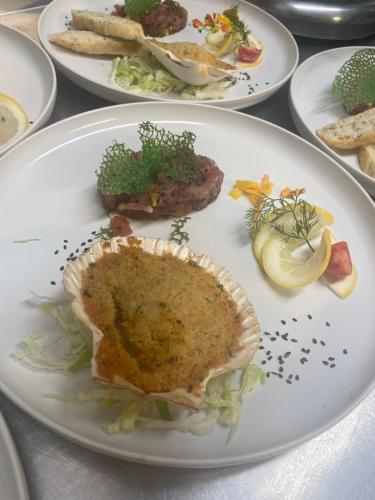 a group of plates of food on a table at Ski Lodge Pampeago in Tesero