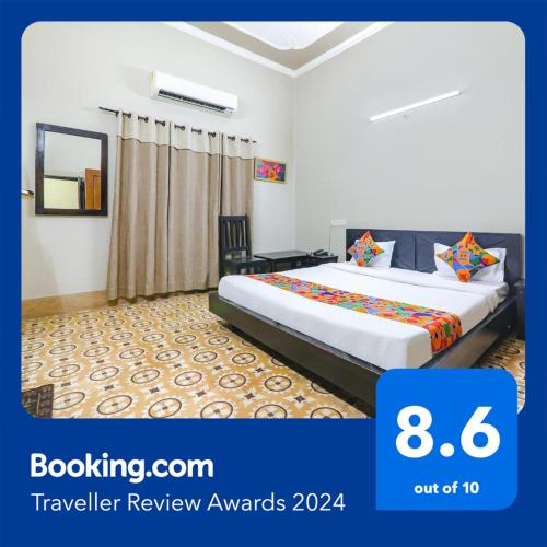 a hotel room with a bed in a room at FabHotel Harmony in Colonelganj