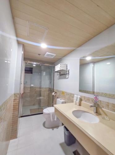 a bathroom with a toilet and a sink and a shower at 456 Hotel in Baguio