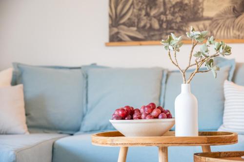 a table with a bowl of fruit and a vase at Marsella in Port de Soller