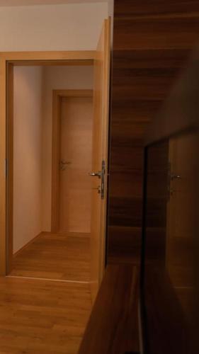 an open door to a room with a wooden floor at Suite 1 - Krems an der Donau in Rossatz