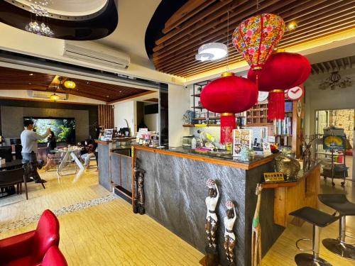 a restaurant with a bar with red lanterns at Circle B&B in Jian