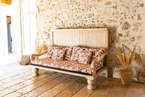 a bed in a room with a wall at Maison Bournissac in Noves