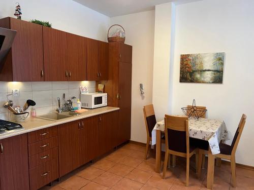 a small kitchen with a table and a microwave at Apartament Chopina 2 in Węgorzewo