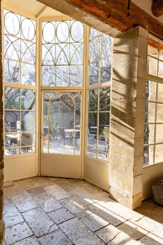 an empty room with large windows and a patio at Maison Bournissac in Noves