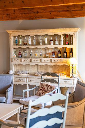 a room with a wooden shelf with bottles on it at Maison Bournissac in Noves