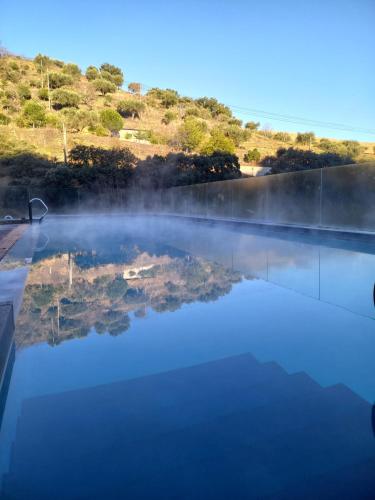 a pool of water with a reflection in the water at Longroiva Hotel Rural in Longroiva