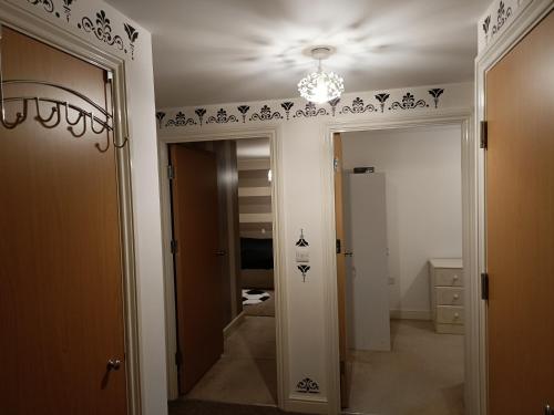 a hallway with black and white stencils on the ceiling at Stylish 2BD near Gatwick Airport in Crawley in Crawley