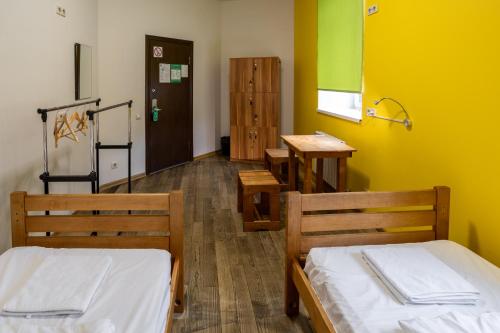 a room with two beds and a yellow wall at DREAM Hotel Kyiv in Kyiv