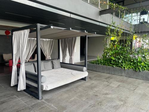 a bed with a canopy in a room with plants at Anggun KL MY in Kuala Lumpur