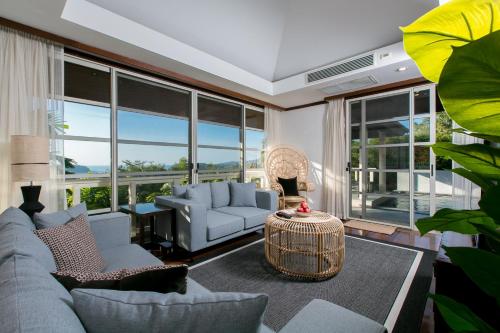 a living room with a couch and a table at Katamanda Villa Aliya Jacuzzi Pool near Kata Beach in Kata Beach