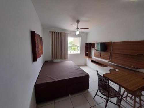 a bedroom with a bed and a table with chairs at Prive Riviera - Apartamentos JN in Caldas Novas