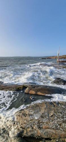 a body of water with rocks and the ocean at Kungälv-Kode Golf Club Bed & Breakfast in Kode