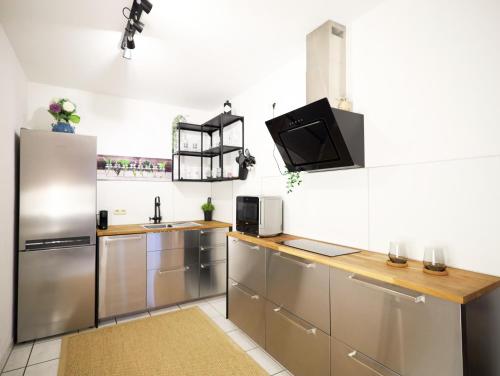 a kitchen with stainless steel appliances and a sink at Gemütliche 2Zi. Wohnung in Seligenstadt