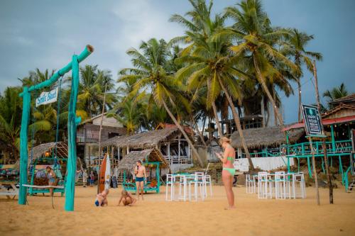 a group of people playing on the beach at Smile Beach Home in Galle