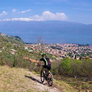 a person riding a bike down a hill at Cà del borgo Historic Village in Toscolano Maderno