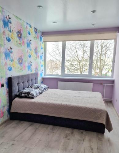 Llit o llits en una habitació de Narva Appart