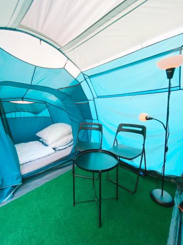 a tent with two chairs and a table in it at Kemp Děčín in Děčín