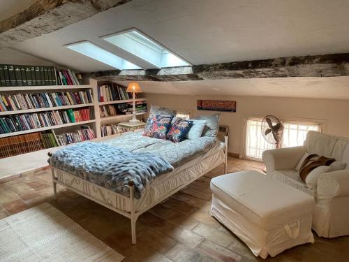 a bedroom with a bed and a book shelf at Ma Maison in Vence