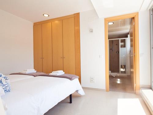 a bedroom with a bed and a wooden cabinet at Charmsuites Nou Rambla in Barcelona