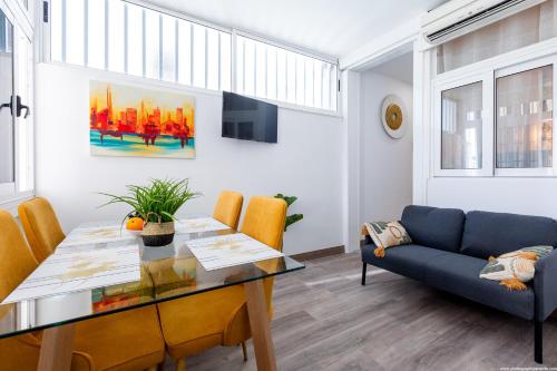 a living room with a table and a couch at El Drago Apartment Fiber ,A/C,Near Ocean in Costa Del Silencio