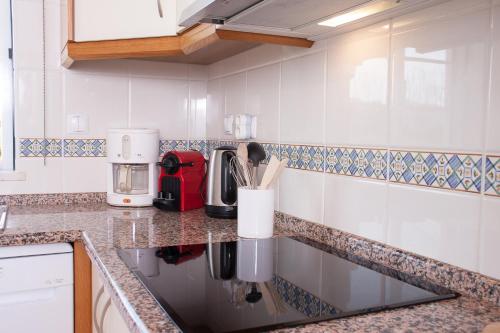 a kitchen with a counter top with a coffee maker at Vila Rosal Margarida Apartment in Albufeira