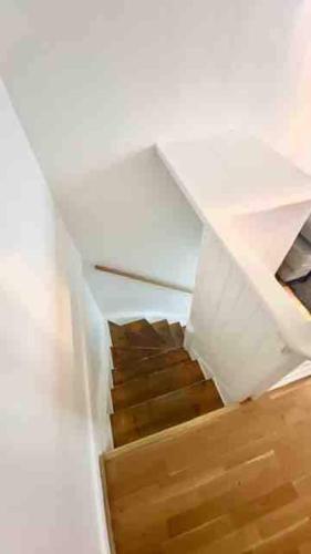 a staircase in a room with a white ceiling at Cozy Cottage In Central Gothenburg in Gothenburg