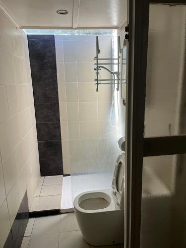 a small bathroom with a toilet and a shower at Gorgeous Master Bedroom with Own Bath in Frankston