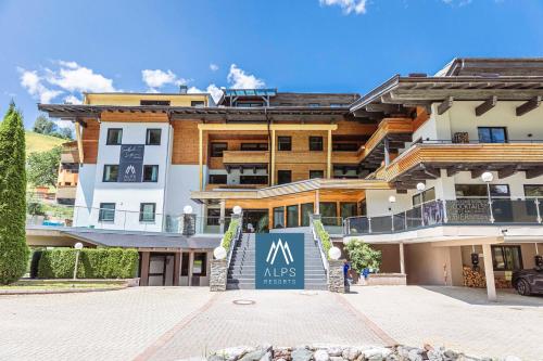 a large building with a sign in front of it at Saalbach Suites by ALPS RESORTS in Saalbach-Hinterglemm