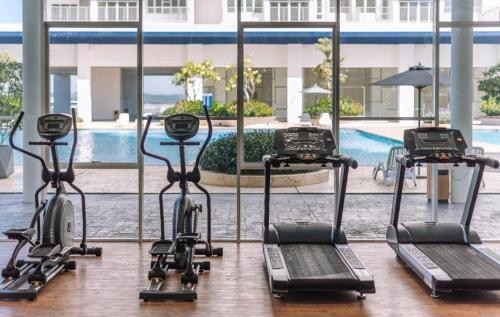 a group of exercise bikes in front of a pool at Eighty2 House Palmyra Residence in Bangi
