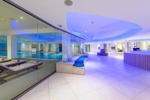 a lobby with a row of blue chairs in a building at Asterias Beach Hotel in Ayia Napa